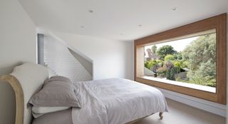 white master bedroom with picture window in loft conversion