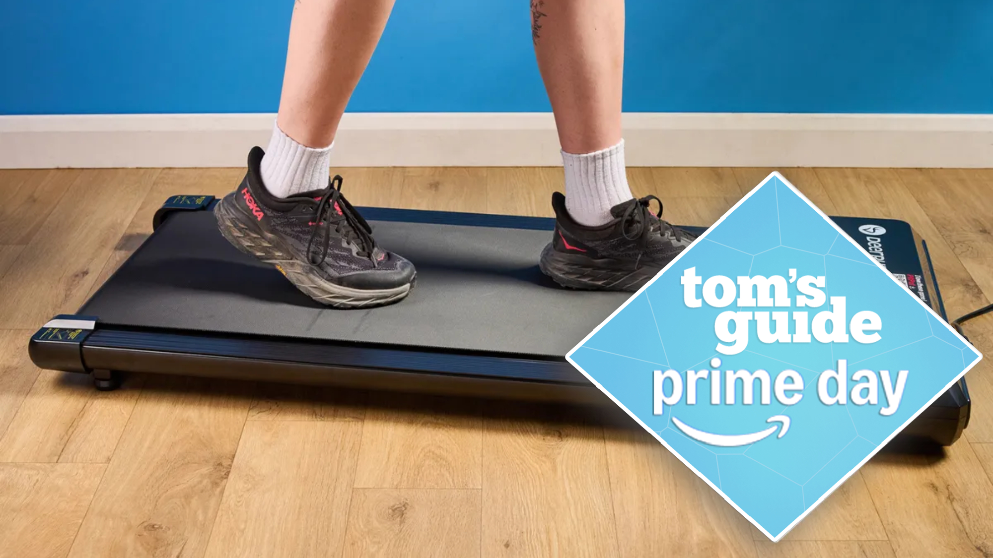the DeerRun Q1 Mini treadmill with a person walking on the pad wearing hoka sneakers, with a tom&#039;s guide prime day deals badge