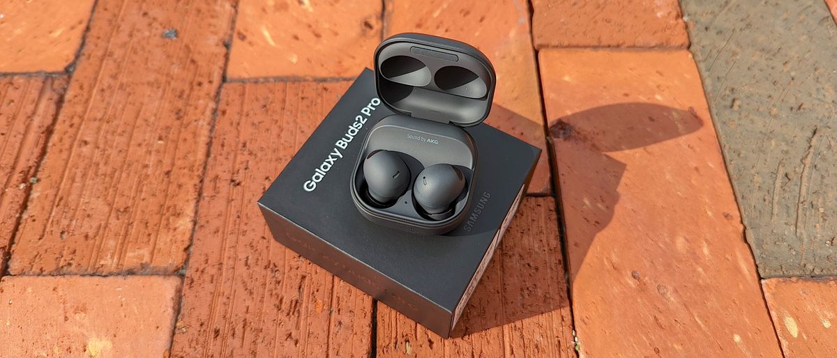 The Samsung Galaxy Buds 2 Pro unboxed and displayed atop an exposed brick surface