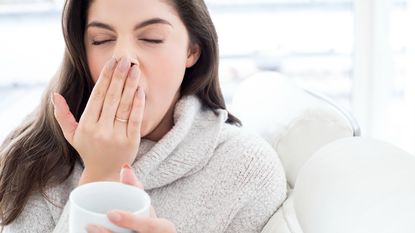 Woman looks tired and is yawning