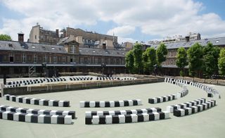 Black and white cube-shaped stools were laid out in three concentric circles to form the schoolyard catwalk
