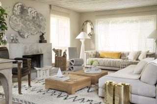 Neutral living room with fireplace and armless sofa