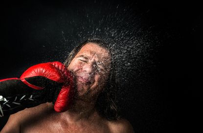 Sweating fighter is punched in the face