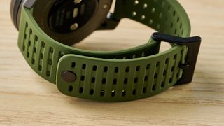 an outdoor-style smartwatch with a big screen and titanium bezel case with a forest green strap