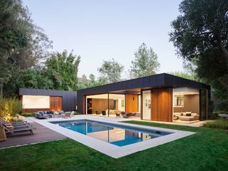 Modern home with large patio with fire pit and and swimming pool