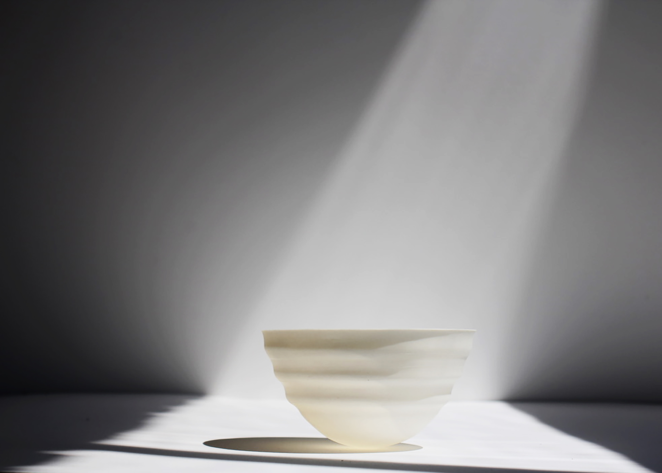 A beam of light shines on a bowl