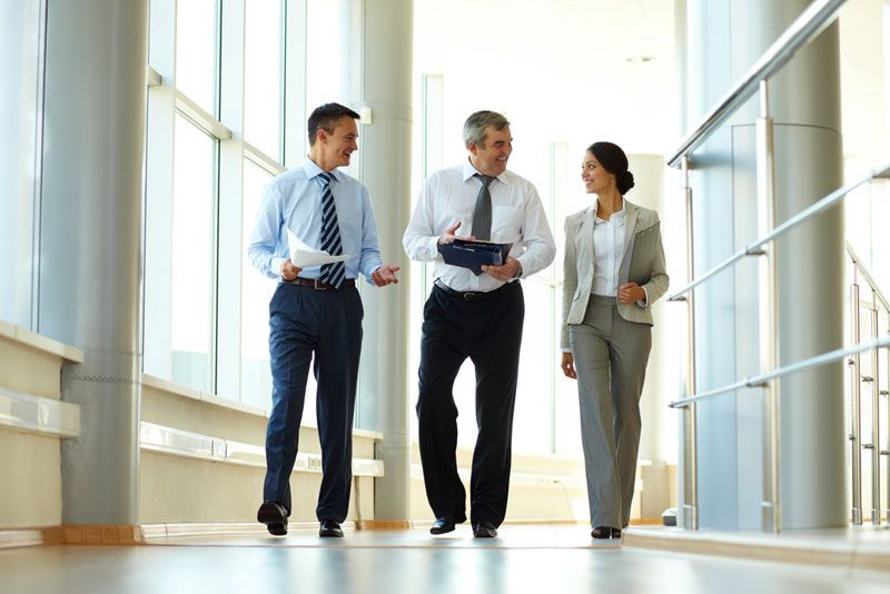 People walking around an office.