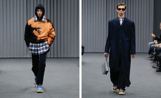 A separate front on view of two models on the catwalk, the left with a jumper over a shirt and hood up, the right with an overcoat and black tinted sunglasses