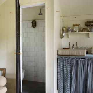 Bathroom with cream wall panelling and walk in shower
