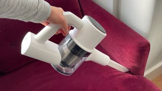 The Roidmi Z1 Air being used in handheld mode to clean a sofa