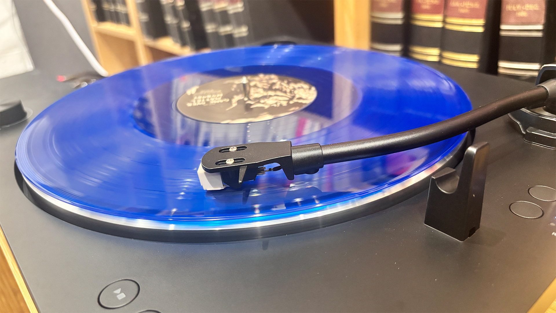 Sharp RP-TT100 Bluetooth turntable playing blue vinyl record