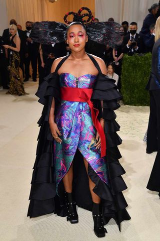 Naomi Osaka is pictured on the MET Gala 2021 red carpet wearing an outfit by Louis Vuitton and beauty look created by Marty Harper for NatureLab Tokyo