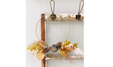 Simple fall gold hoop wreath hanging in hallway from small hook