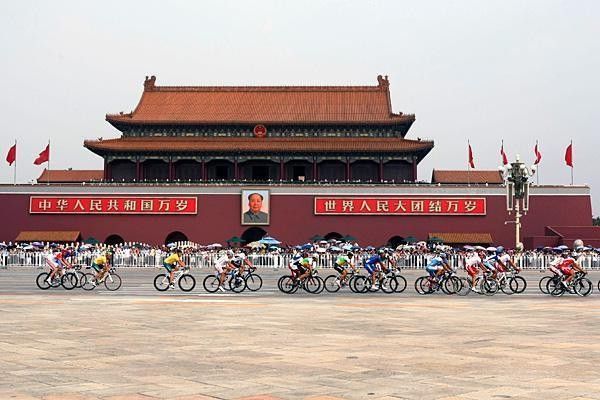 Riders pass Tiananmen Gate at the start of the race.