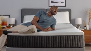A man lies on an Emma Hybrid Comfort mattress