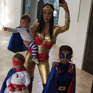women and kids with superhero costume