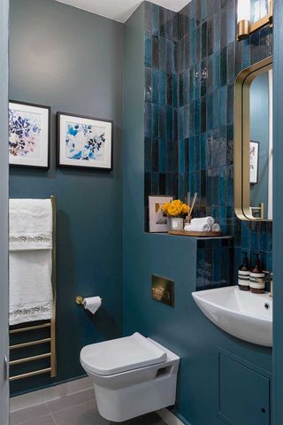 blue bathroom with gold mirror