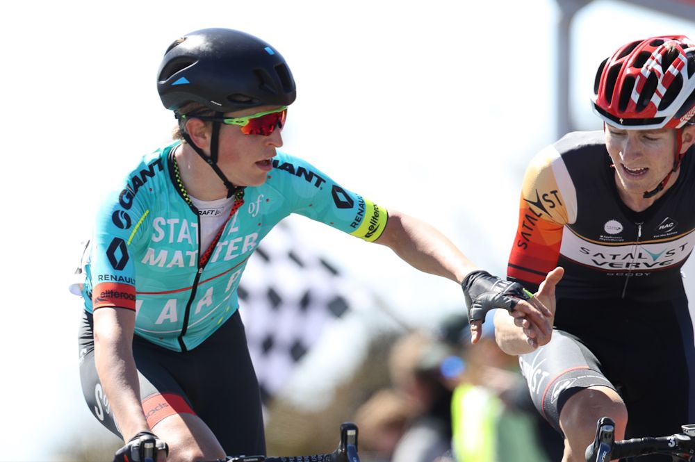 Two riders congratulate each other after finishing a tough stage.
