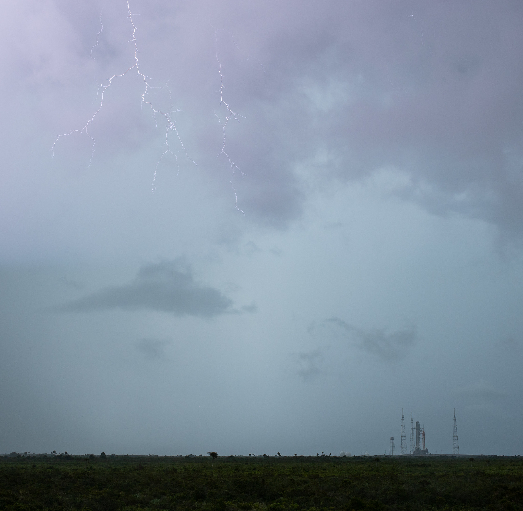 lightning in the sky above a launch pad