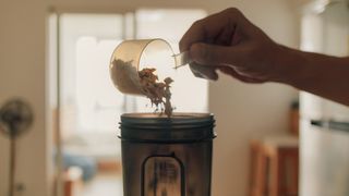 Pouring protein powder into shaker