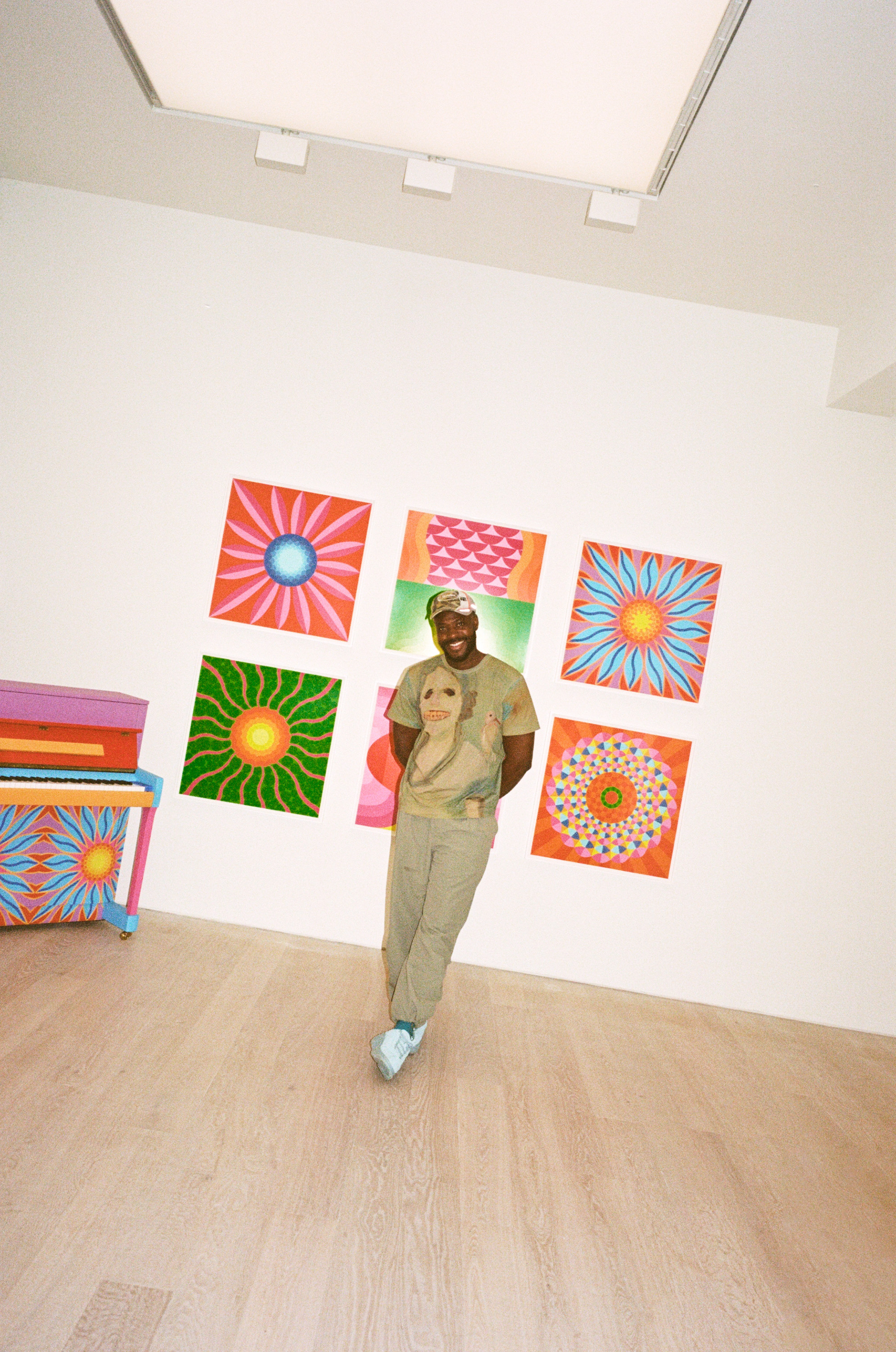 Yinka Ilori against artwork in gallery