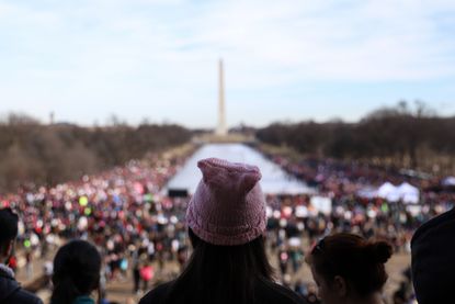 People gather at the Lincoln Memorial reflecting pool to rally before the Women's March on January 20, 2018 in Washington, D.C.