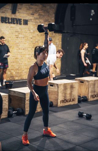 Writer Sam performing a dumbbell snatch during CrossFit in-house throwdown wearing the R.A.D One V2 training shoes