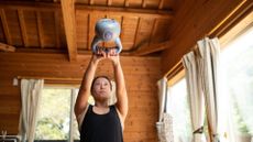 Woman doing kettlebell swing at home