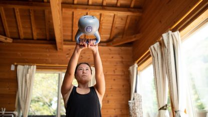 Woman doing kettlebell swing at home