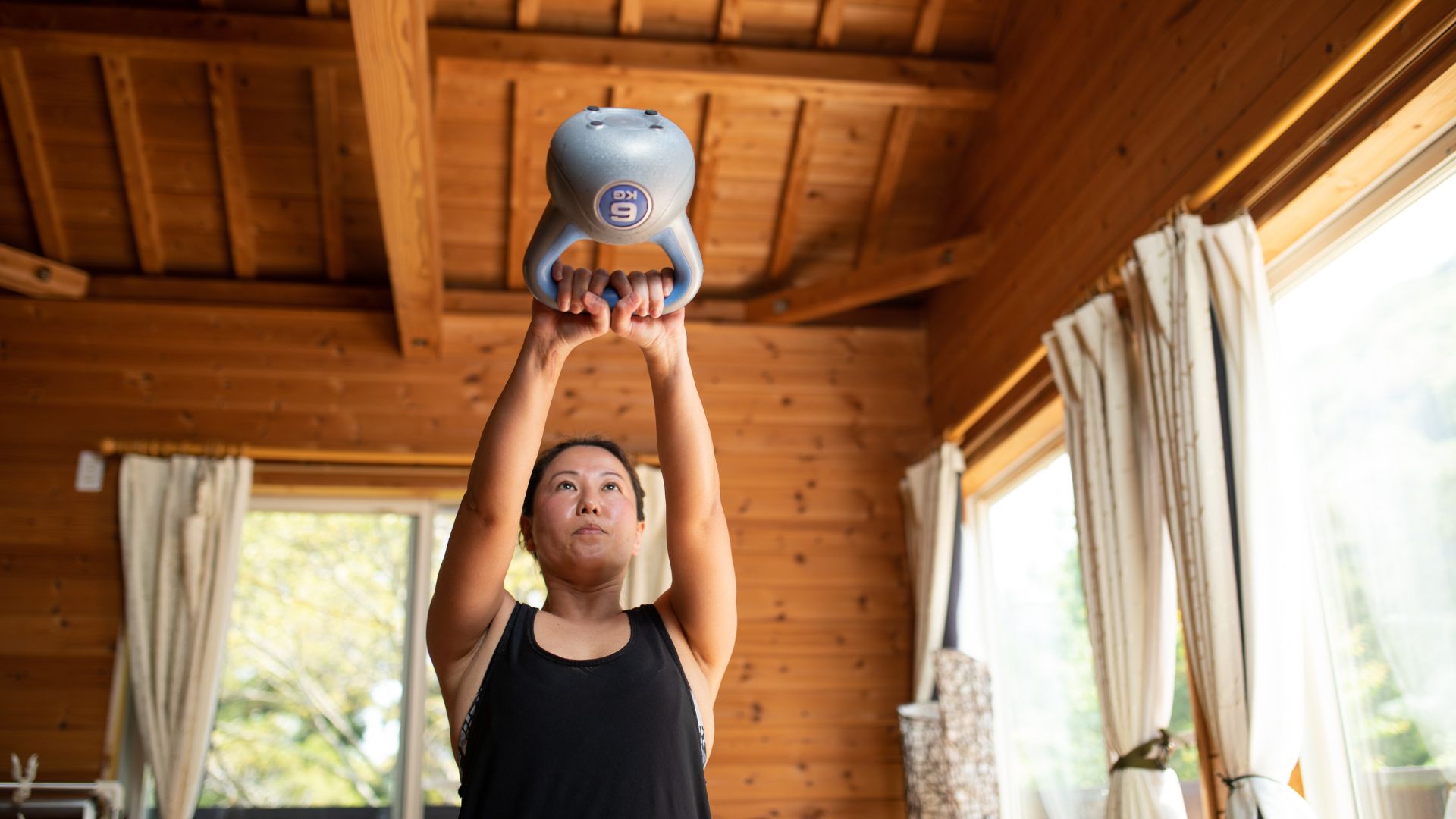 Woman doing kettlebell swing at home
