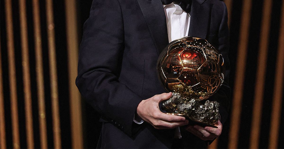 The Ballon d&#039;Or trophy in 2023, as held by Lionel Messi at the ceremony in Paris held by France Football