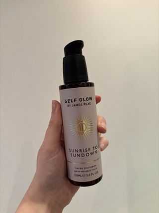 Mica Ricketts holding Self Glow by James Read Sunrise to Sundown Tinted Tan Serum