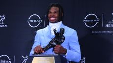 University of Colorado wide receiver Travis Hunter poses with the Heisman Trophy.