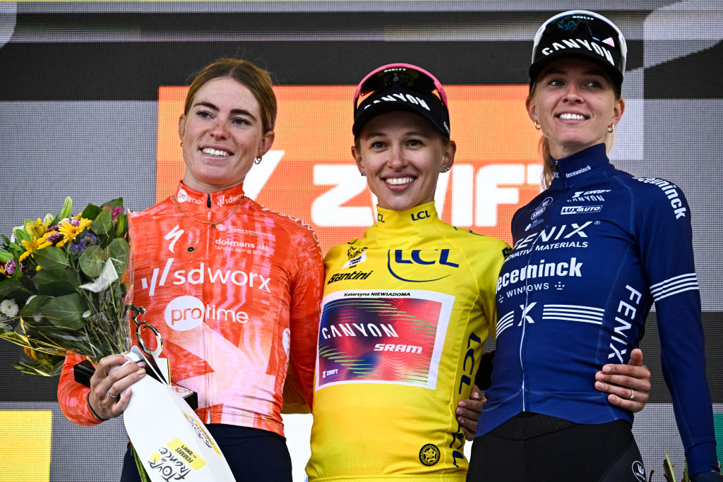 (From L) Stage winner and second placed Team SD Worx - Protime&#039;s Dutch rider Demi Vollering, Overalll leader and first placed Canyon//SRAM Racing team&#039;s Polish rider Katarzyna Niewiadoma wearing the overall leader&#039;s yellow jersey and third placed Fenix-Deceuninck team&#039;s Dutch rider Pauliena Rooijakkers celebrate on the podium after competing in the 8th and last stage of the third edition of the Women&#039;s Tour de France cycling race, a 149.9 km between Le Grand Bornand and the Alpe d&#039;Huez, in L&#039;Alpe d&#039;Huez, south-eastern France, on August 18, 2024. (Photo by JULIEN DE ROSA / AFP) (Photo by JULIEN DE ROSA/AFP via Getty Images)
