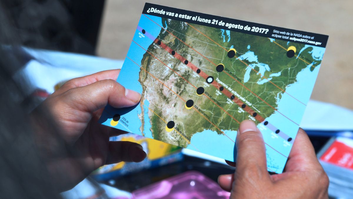 A person holds a solar eclipse map showing the route of the 2017 solar eclipse on Aug. 21, 2017.