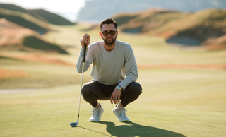 A golfer lines up a putt