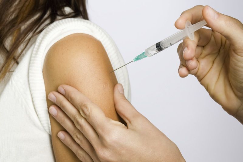 A woman receives a vaccinations