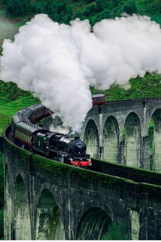 steam train travelling over a bridge