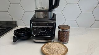 The Ninja Foodi Blender & Soup Maker HB150UK being used to crush nuts