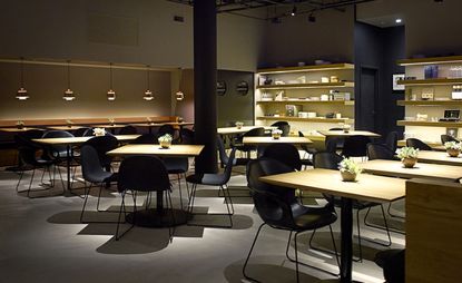 Restaurant with grey chairs and wooden tables