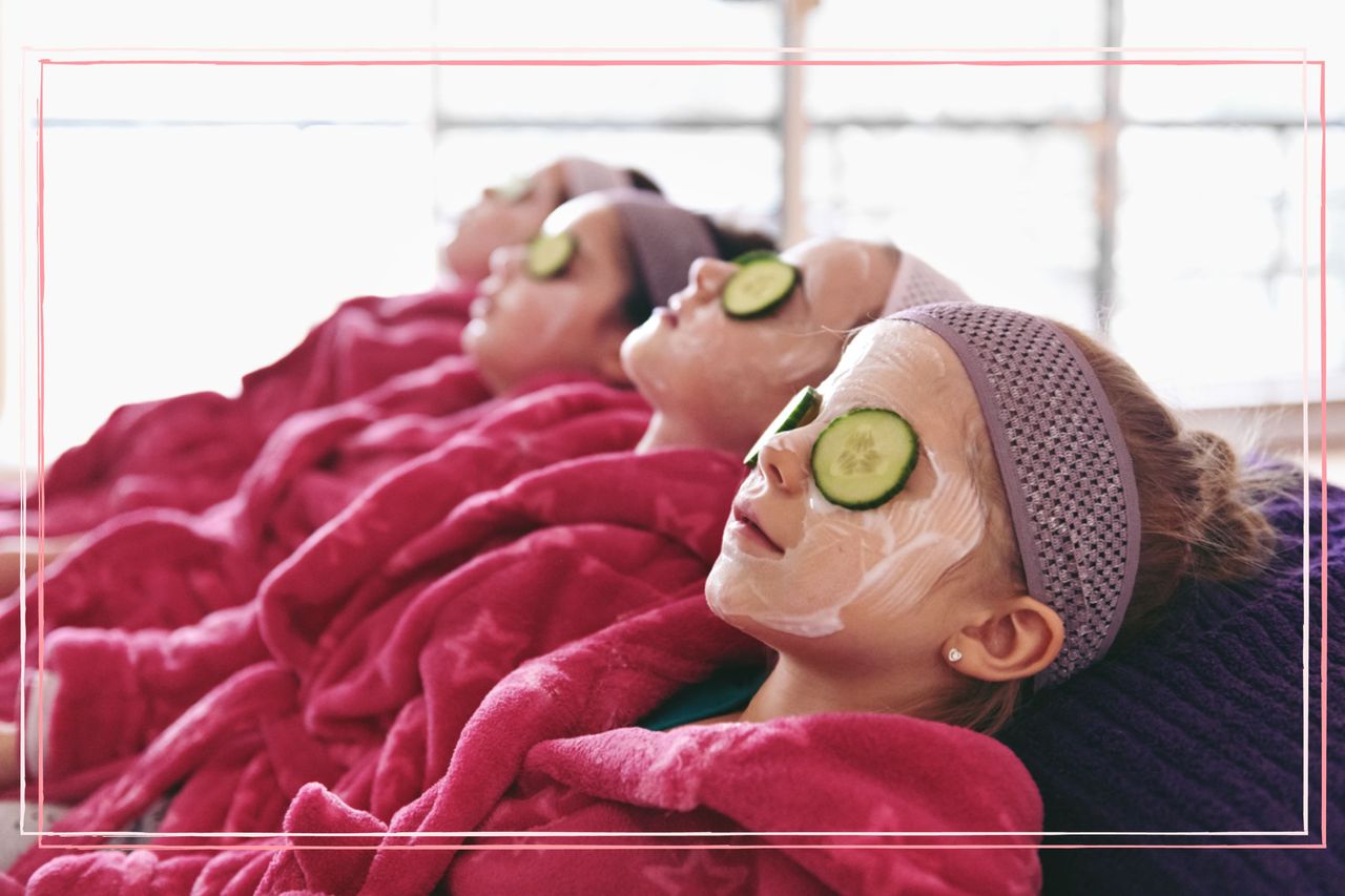 Four girls in pink dressing gowns lying with cucumber on their eyes