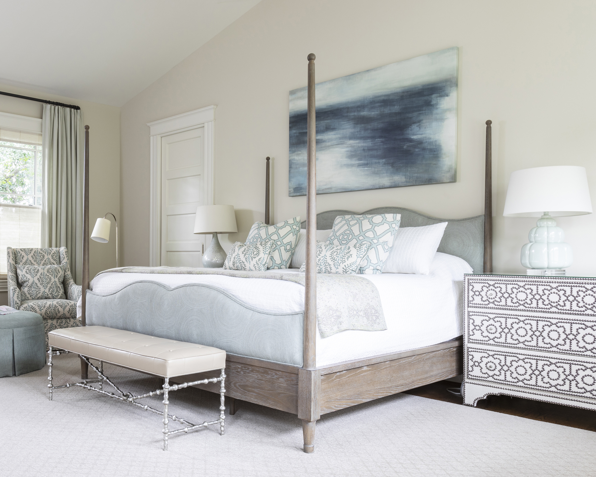 A bedroom with pale blue bed linen and pale wood four poster bed illustrating simple bedroom ideas.