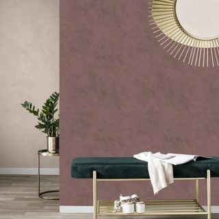 Maroon plaster wallpaper in a room with a gold mirror