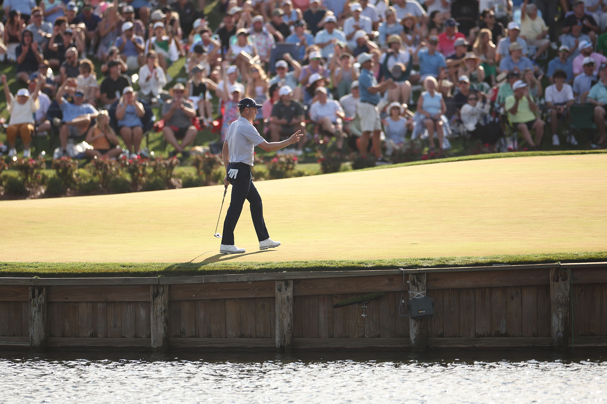 Justin Thomas thanking fans after putting on the 17th green at TPC Sawgrass