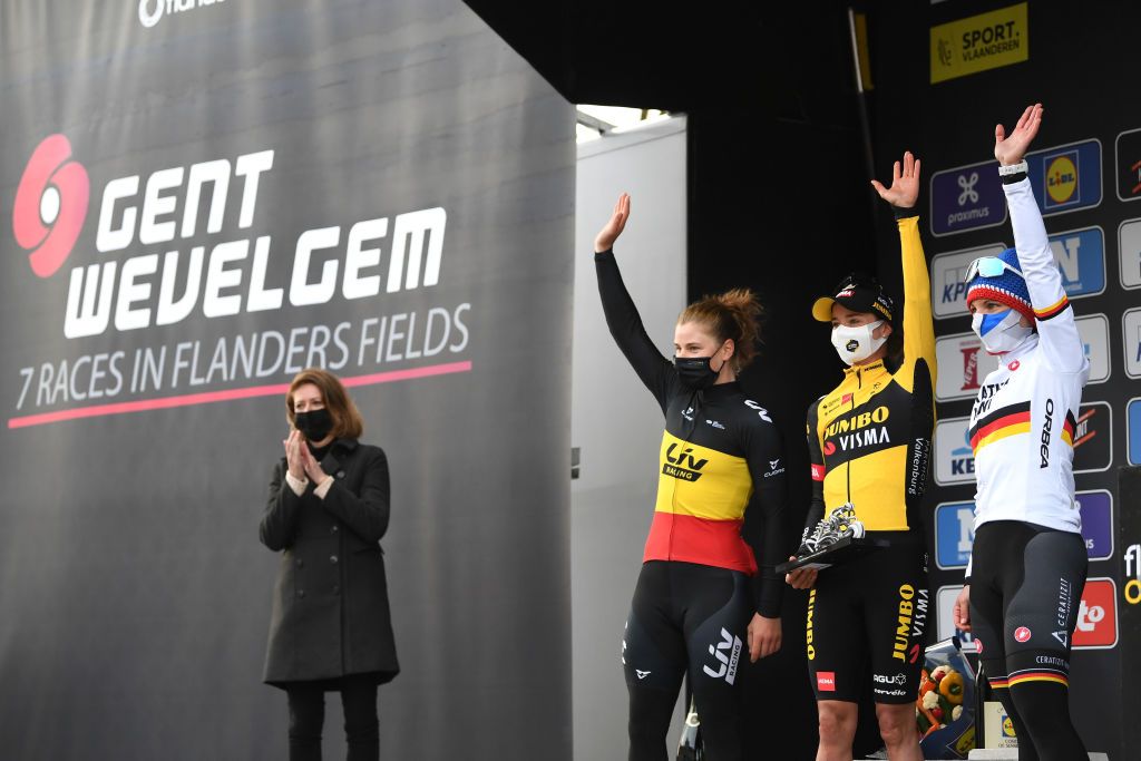 WEVELGEM BELGIUM MARCH 28 Podium Lotte Kopecky of Belgium and Team Liv Racing Marianne Vos of Netherlands and Team Jumbo Visma Lisa Brennauer of Germany and Ceratizit WNT Pro Cycling Team Celebration during the 10th GentWevelgem In Flanders Fields 2021 Womens Elite a 1417km race from Ypres to Wevelgem Mask Covid Safety Measures Trophy GWE21 GWEWomen FlandersClassic UCIWWT on March 28 2021 in Wevelgem Belgium Photo by Tim de WaeleGetty Images