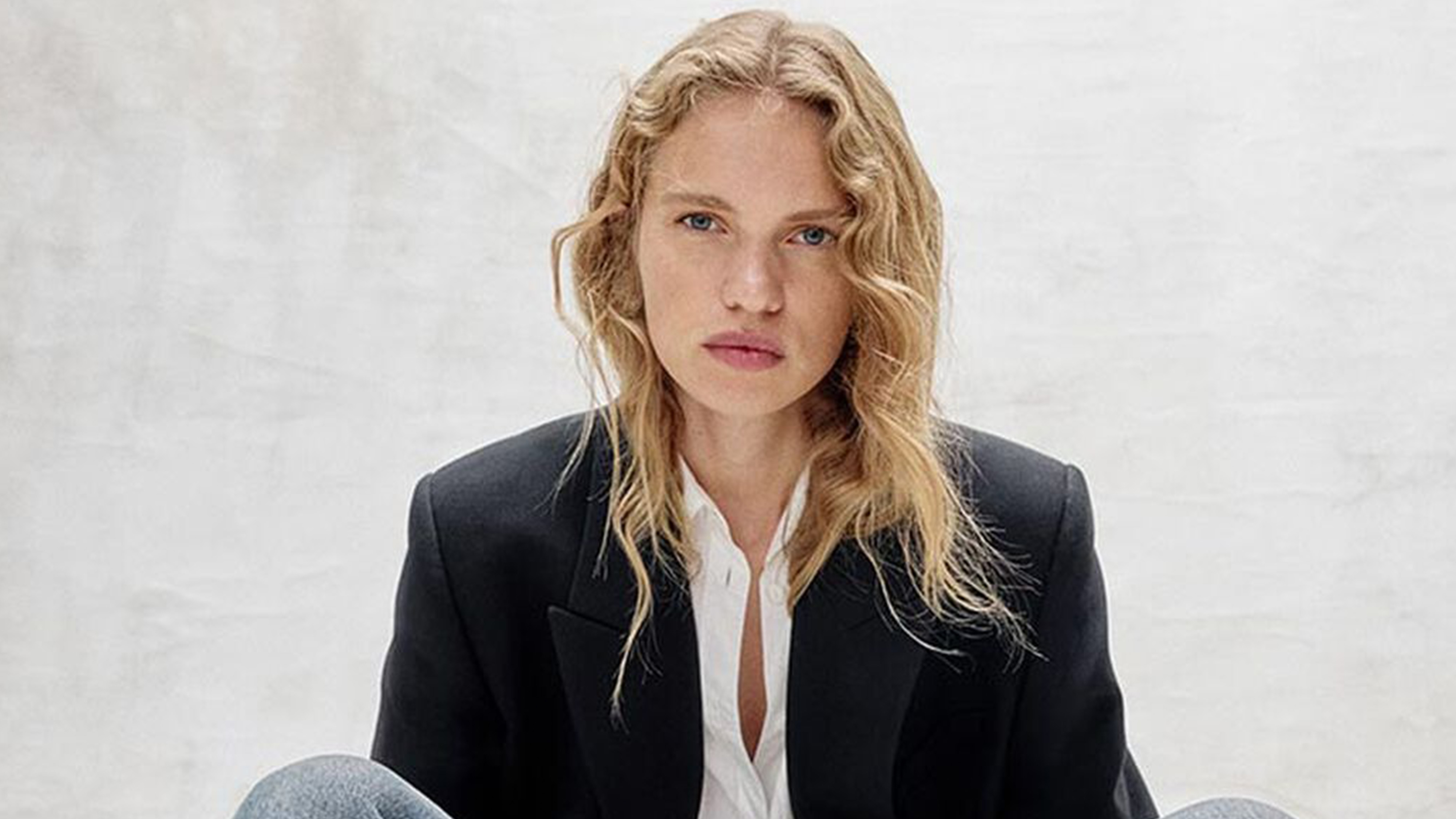 Rag & Bone model wearing a black blazer and white button down.