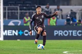 Mexico midfielder Edson Alvarez (#4) dribbles up field during the Concacaf Nations League Final match between Mexico and the United States on March 24, 2024 at AT&T Stadium in Arlington, Texas. (Photo by Matthew Visinsky/Icon Sportswire via Getty Images)