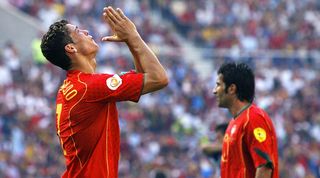 Cristiano Ronaldo reacts to a missed chance for Portugal at Euro 2004 as Luis Figo looks on in the background.