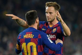Barcelona's Croatian midfielder Ivan Rakitic (R) congratulates Barcelona's Argentine forward Lionel Messi for his second goal during the Spanish league football match between FC Barcelona and Real Valladolid FC at the Camp Nou stadium in Barcelona on October 29, 2019. (Photo by LLUIS GENE / AFP) (Photo by LLUIS GENE/AFP via Getty Images)