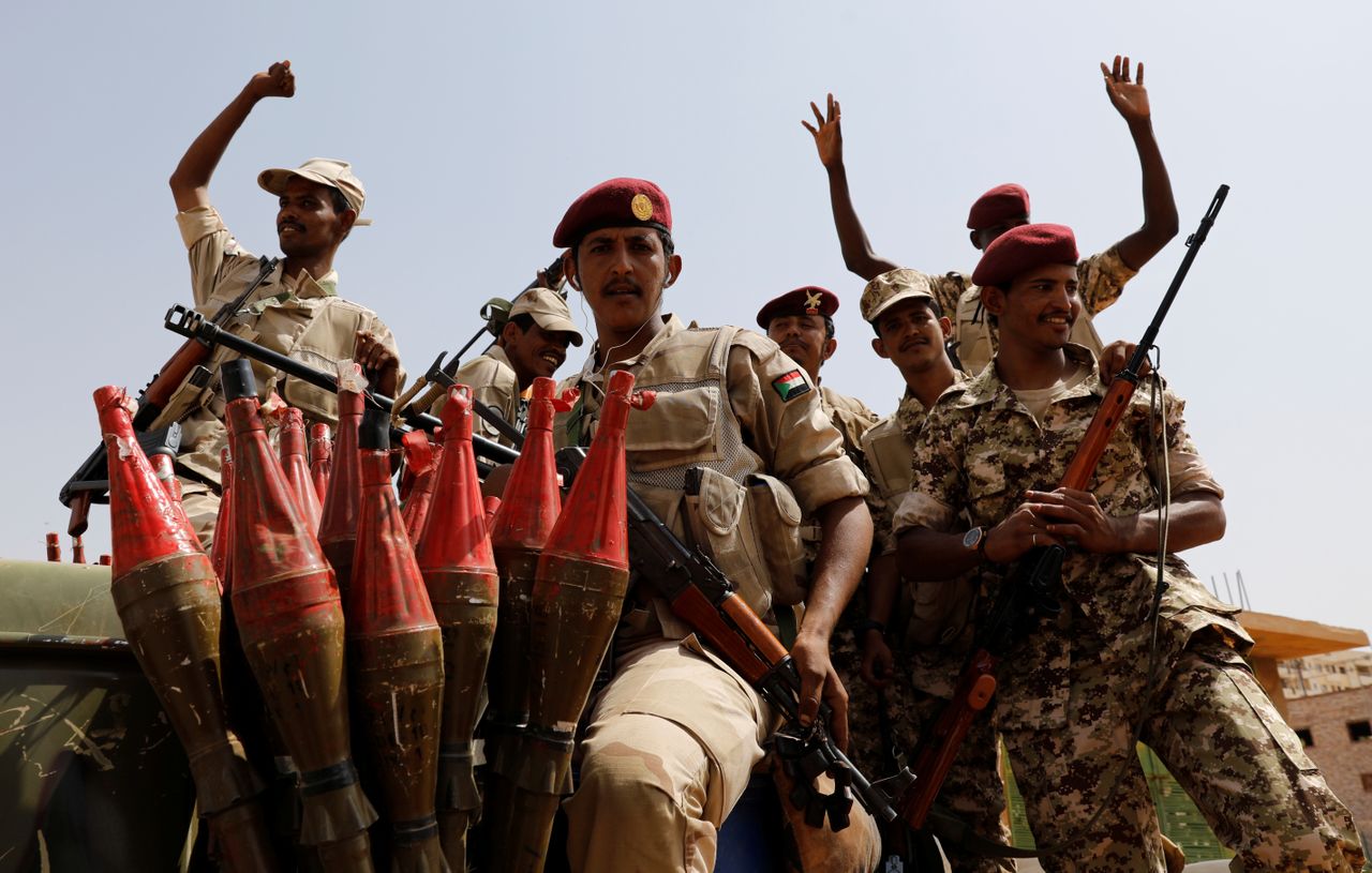 Sudan&amp;#039;s paramilitary Rapid Support Forces soldiers greet people as they secure a site in Khartoum.